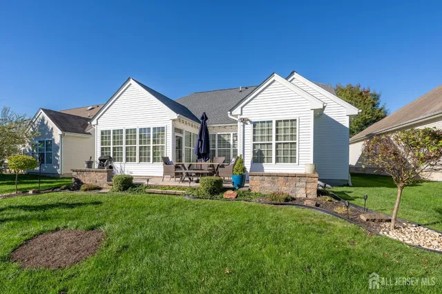 a front view of a house with a yard and outdoor seating
