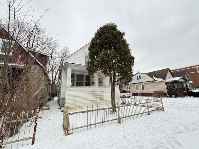 a view of a house with wooden fence