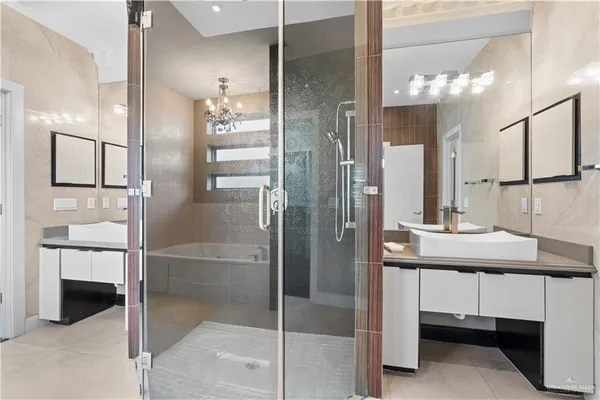 a bathroom with a shower a sink and a mirror