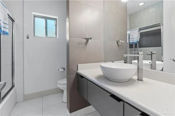a view of bathroom with a sink and mirror