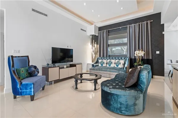a living room with furniture and a flat screen tv