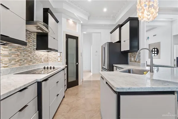 a kitchen with stainless steel appliances granite countertop a sink and refrigerator