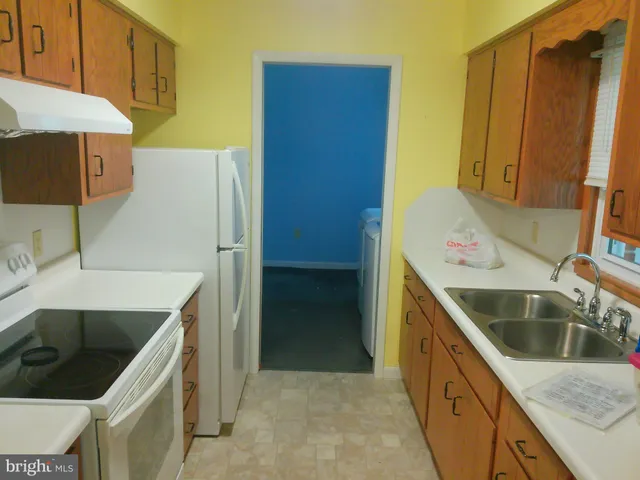 a kitchen with a sink and a refrigerator
