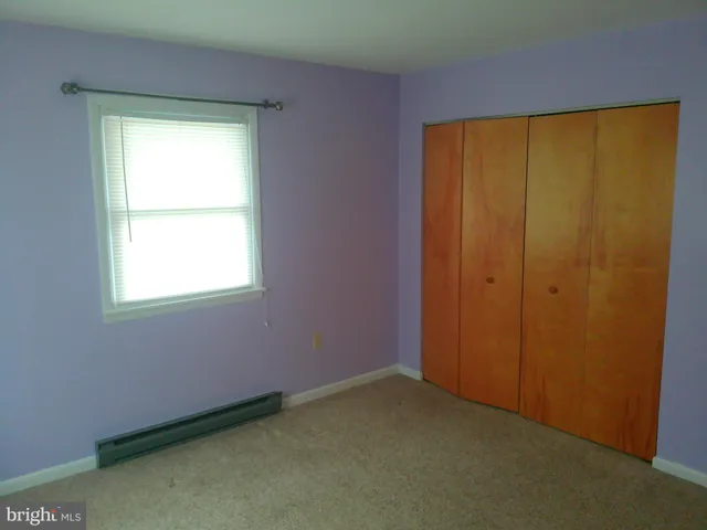 a view of a yard in front of a house with large tree