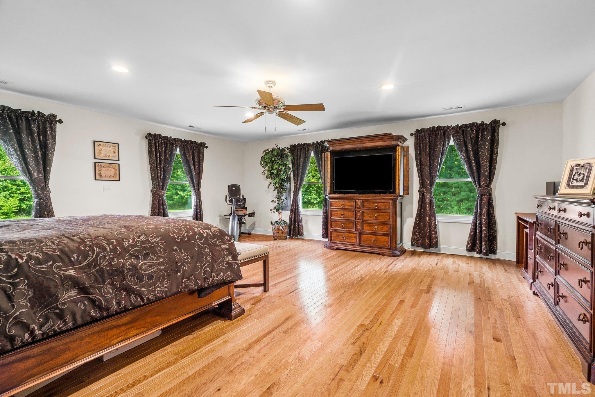 5012 Payton Drive Rougemont, NC 27572 - Photo 16 of 47 a spacious bedroom with a bed and a flat screen tv