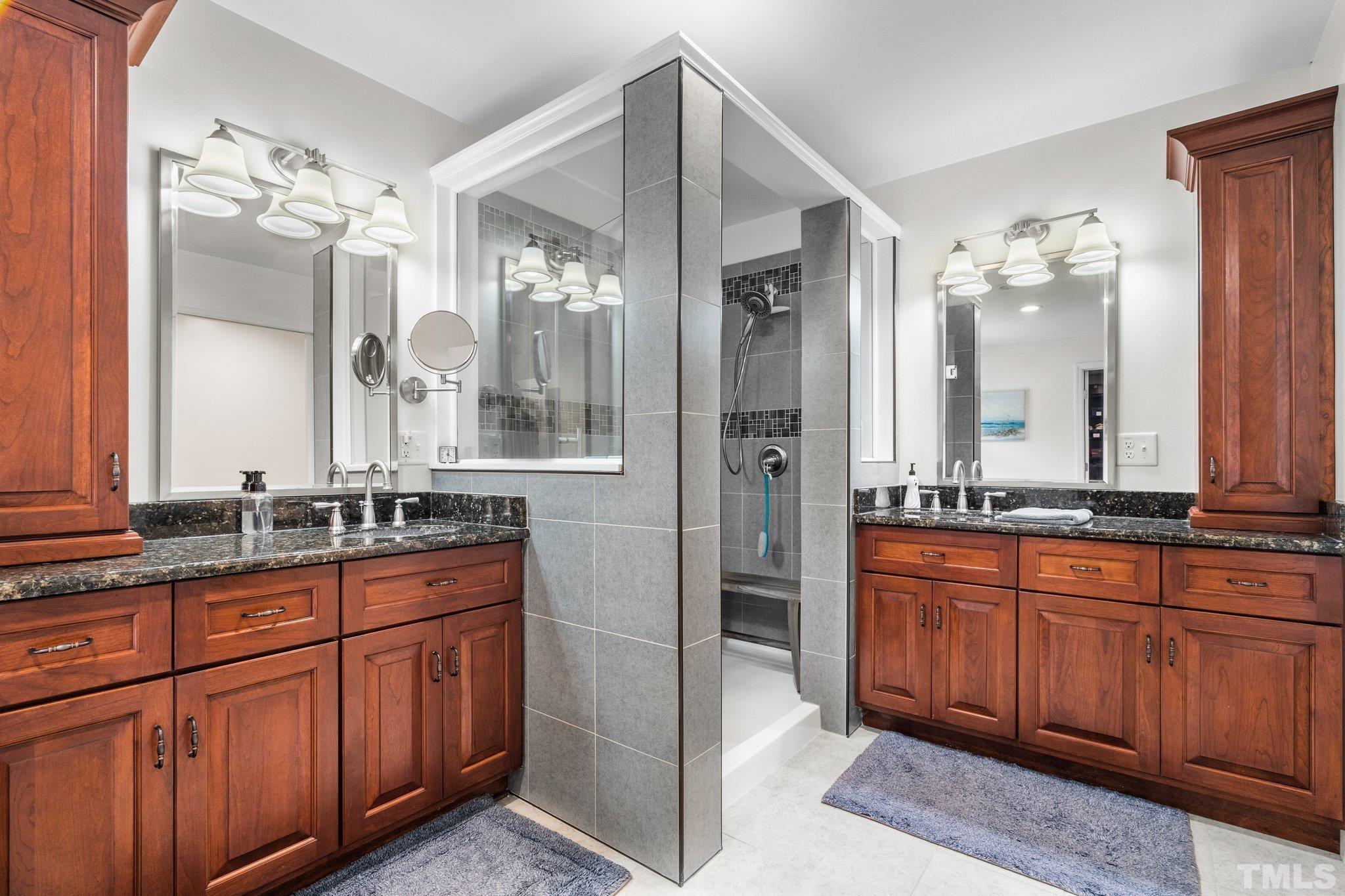 5012 Payton Drive Rougemont, NC 27572 - Photo 19 of 47 a spacious bathroom with a granite countertop double vanity and a mirror