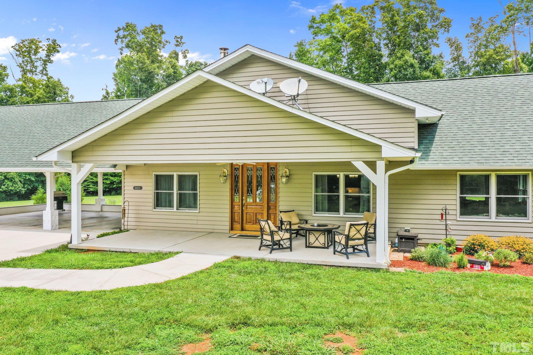 5012 Payton Drive Rougemont, NC 27572 - Photo 3 of 47 a front view of house with a garden and patio