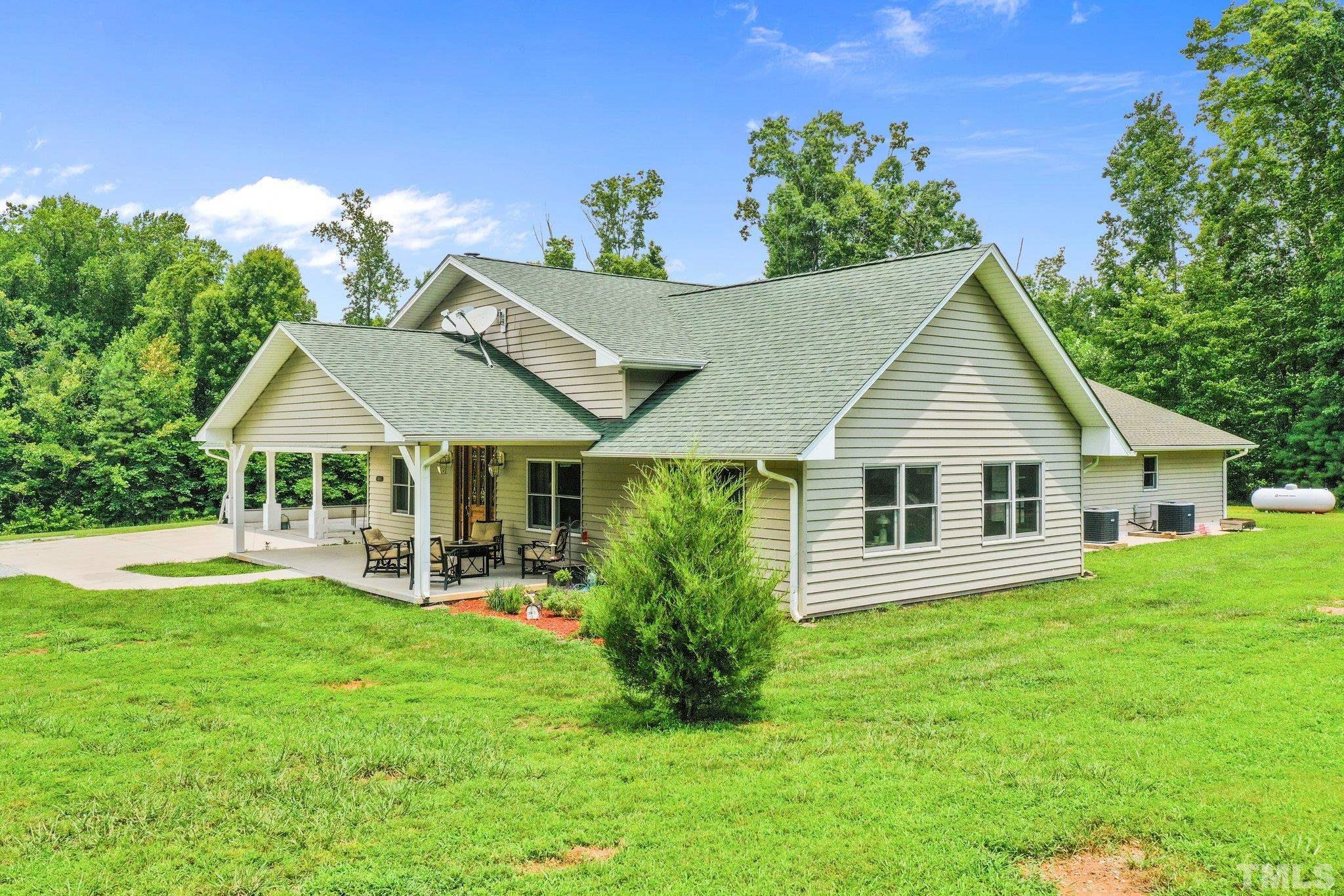 5012 Payton Drive Rougemont, NC 27572 - Photo 32 of 47 a view of a house with a yard potted plants and a table