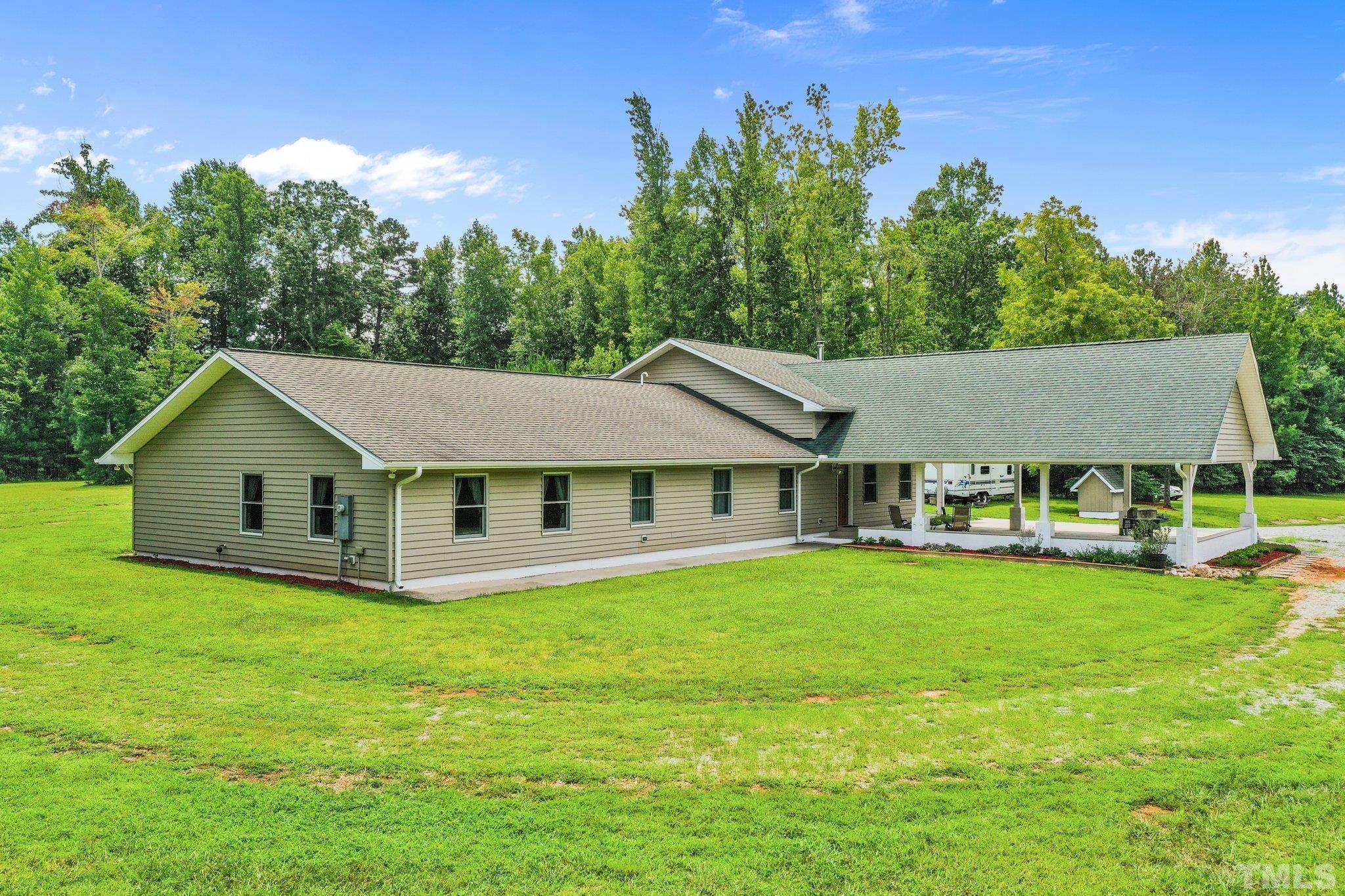 5012 Payton Drive Rougemont, NC 27572 - Photo 33 of 47 a view of a house with a yard potted plants and large tree