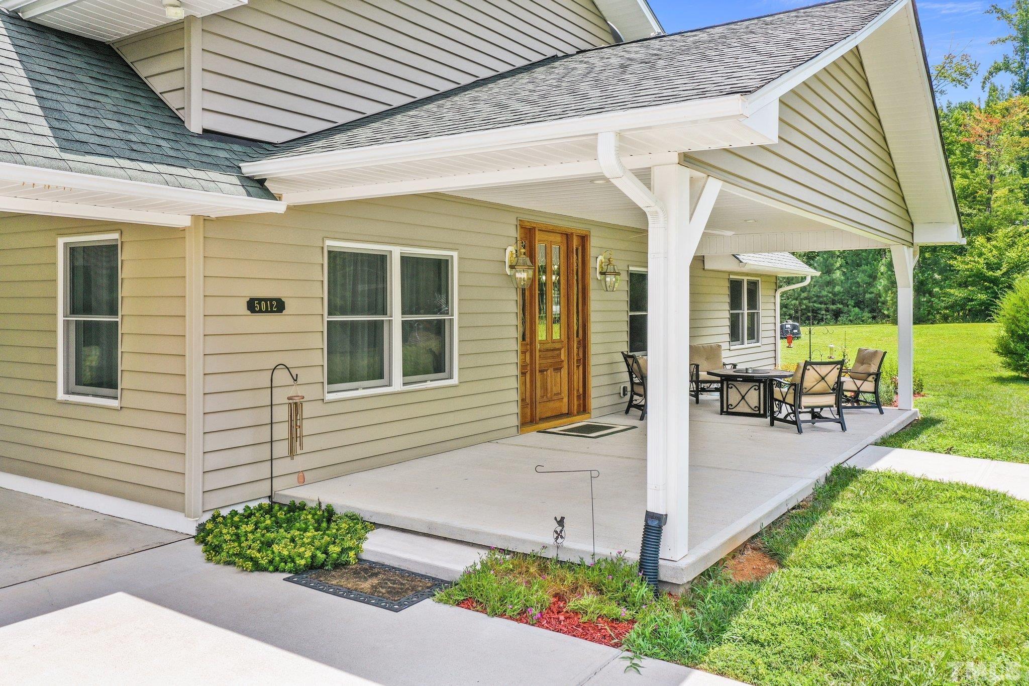 5012 Payton Drive Rougemont, NC 27572 - Photo 4 of 47 a front view of a house with garden