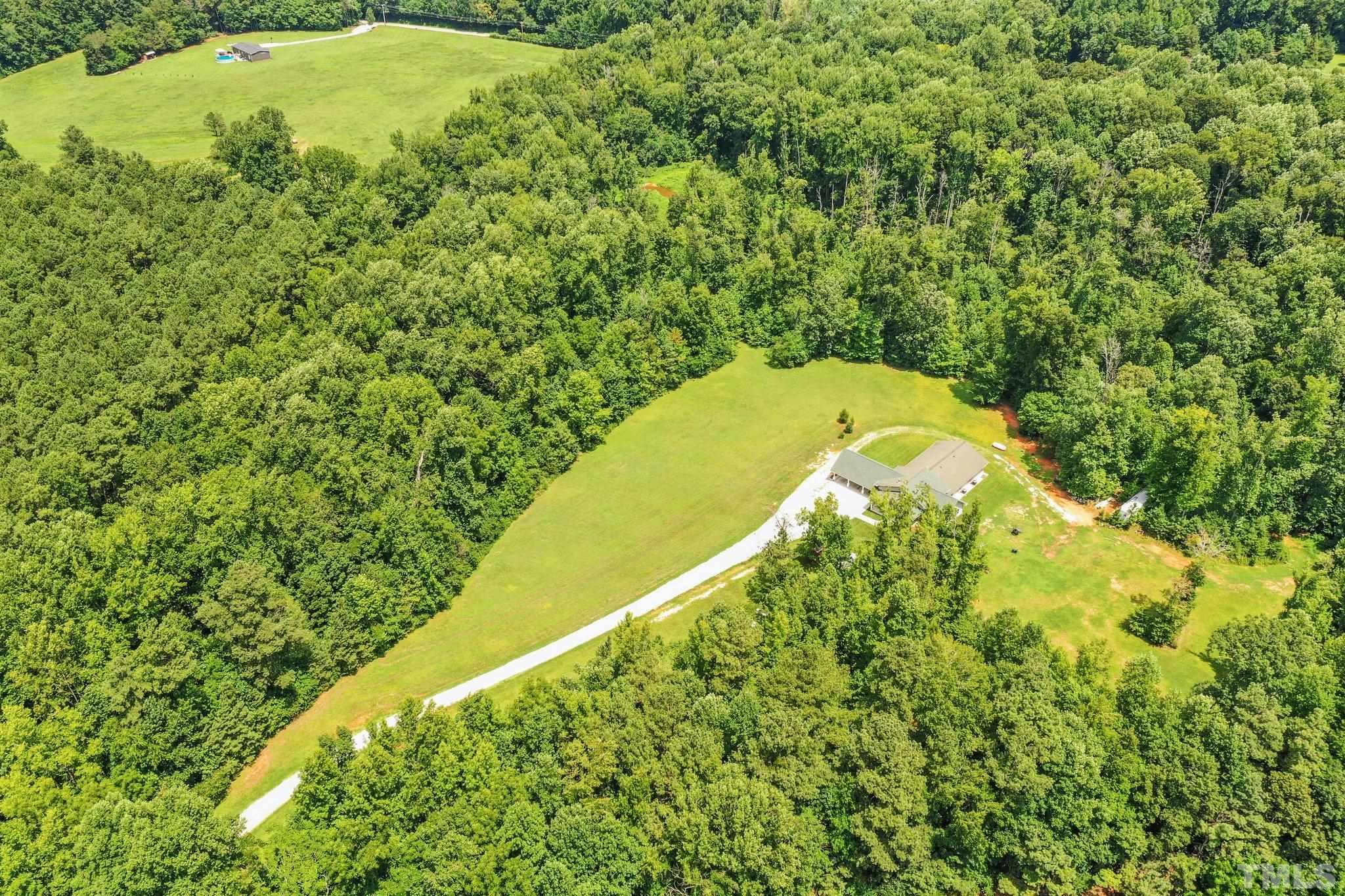 5012 Payton Drive Rougemont, NC 27572 - Photo 42 of 47 a view of a large garden with plants and large trees