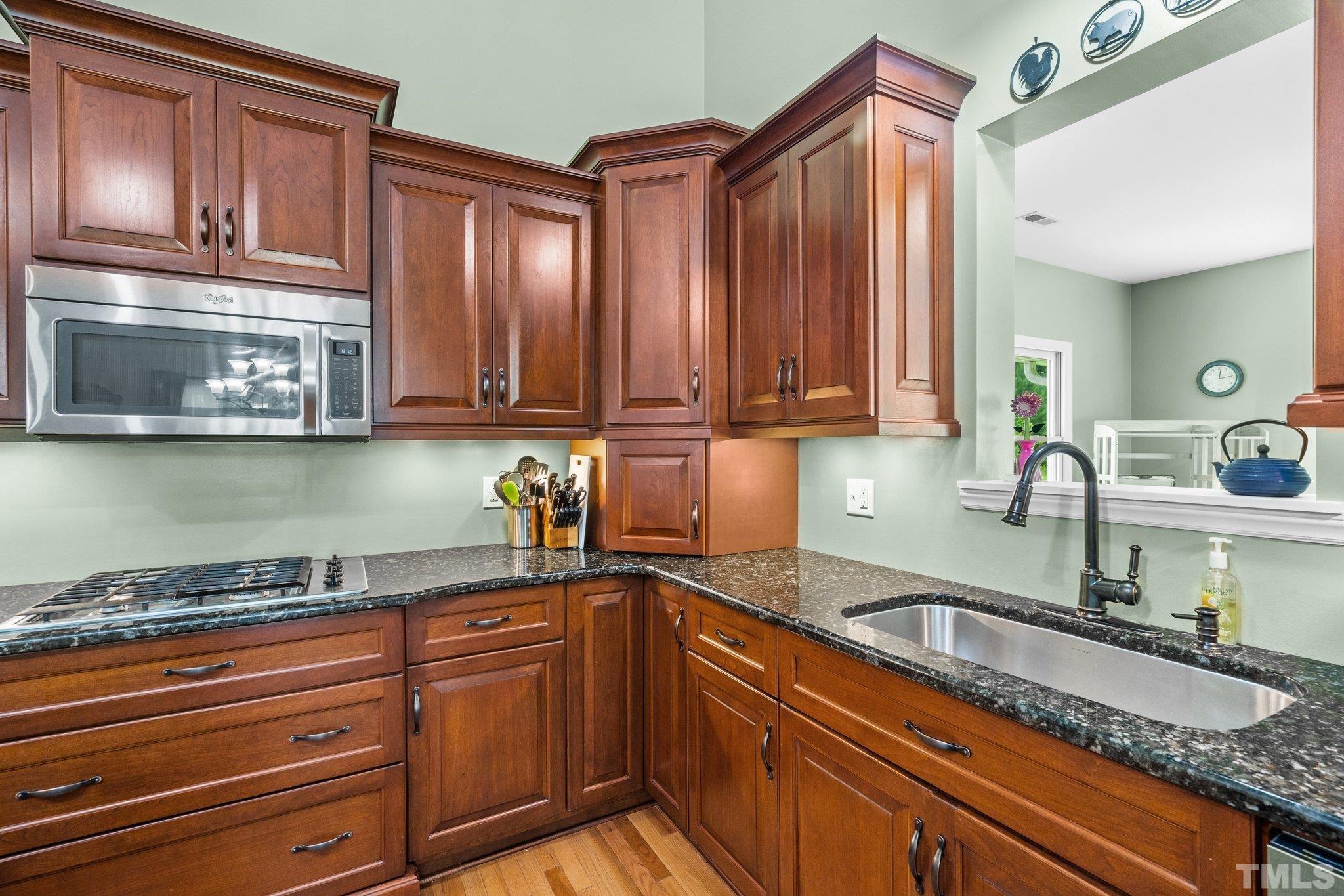 5012 Payton Drive Rougemont, NC 27572 - Photo 9 of 47 a kitchen with granite countertop stainless steel appliances a sink and cabinets