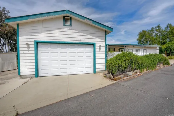 a small white house with a outdoor space