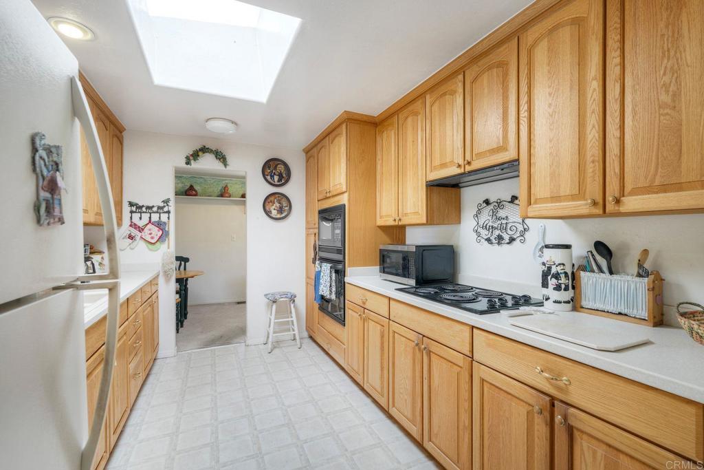 18218 Paradise Mountain Road Valley Center, CA 92082 - Photo 11 of 36 a kitchen with stainless steel appliances a stove a sink and a refrigerator