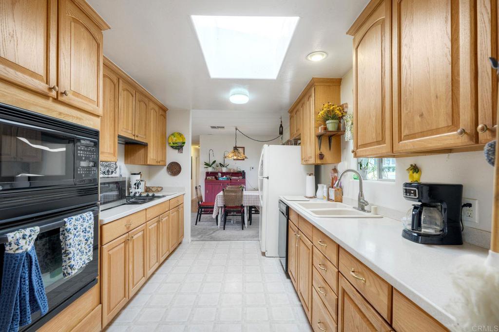 18218 Paradise Mountain Road Valley Center, CA 92082 - Photo 13 of 36 a kitchen with stainless steel appliances granite countertop a sink and cabinets