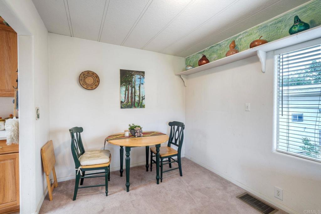 18218 Paradise Mountain Road Valley Center, CA 92082 - Photo 14 of 36 a dining room with furniture and window