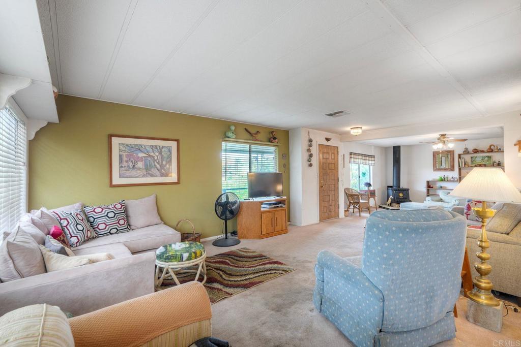 18218 Paradise Mountain Road Valley Center, CA 92082 - Photo 15 of 36 a living room with furniture and a table