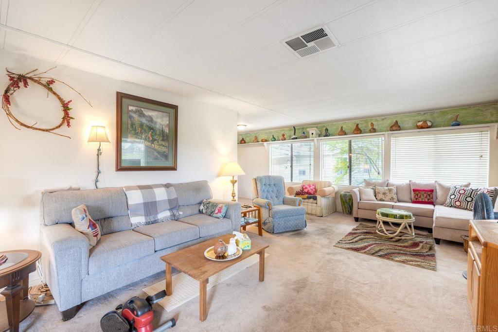 18218 Paradise Mountain Road Valley Center, CA 92082 - Photo 17 of 36 a living room with furniture and a large window