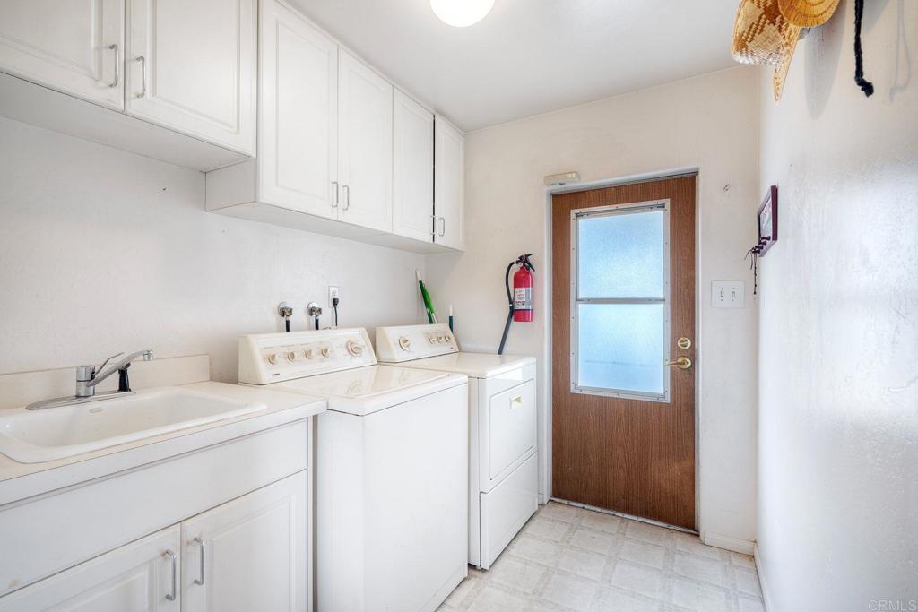 18218 Paradise Mountain Road Valley Center, CA 92082 - Photo 18 of 36 a utility room with sink dryer and washer
