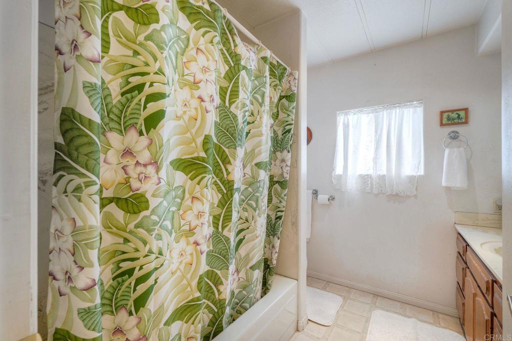 18218 Paradise Mountain Road Valley Center, CA 92082 - Photo 19 of 36 a bathroom with a bathtub and shower