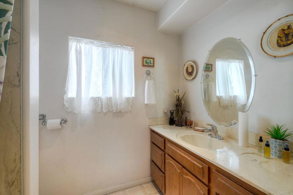 18218 Paradise Mountain Road Valley Center, CA 92082 - Photo 20 of 36 a bathroom with a sink and a mirror