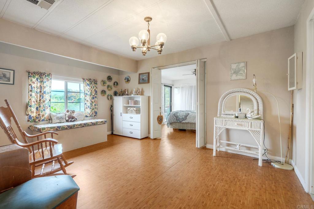 18218 Paradise Mountain Road Valley Center, CA 92082 - Photo 22 of 36 a living room with furniture and a chandelier