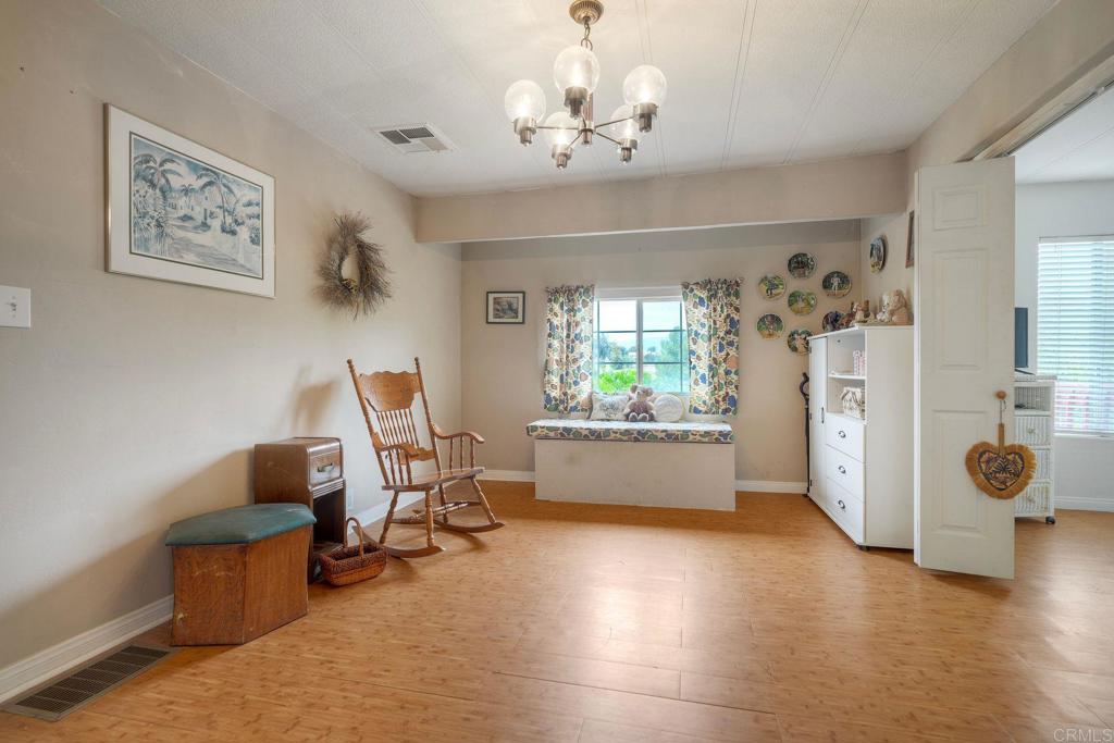 18218 Paradise Mountain Road Valley Center, CA 92082 - Photo 25 of 36 a view of a workspace with furniture and a window