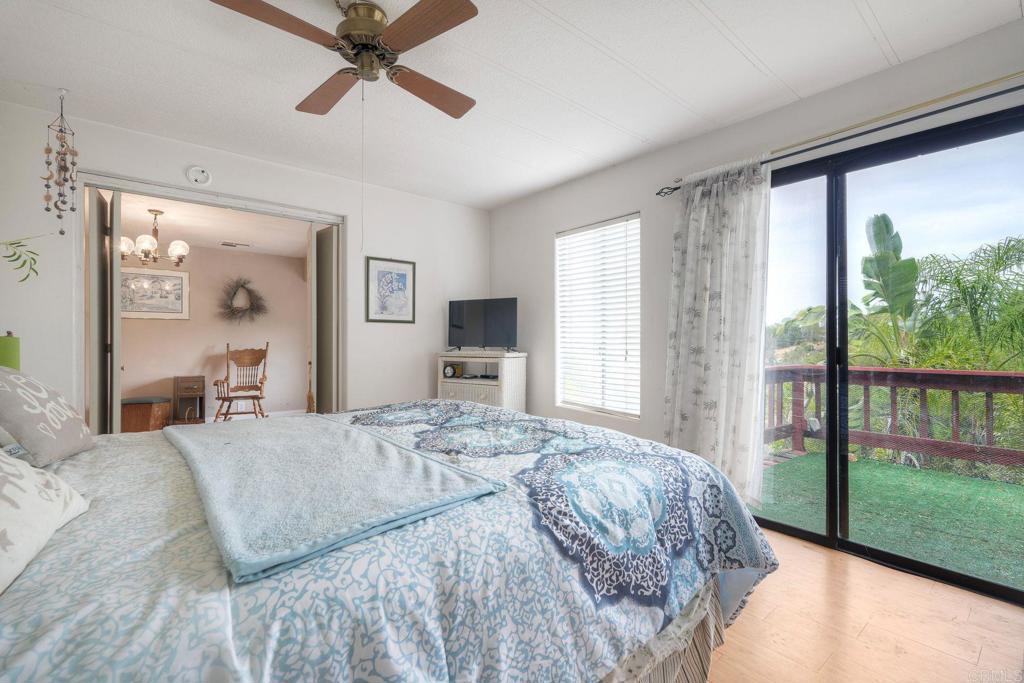 18218 Paradise Mountain Road Valley Center, CA 92082 - Photo 28 of 36 a bedroom with a bed and a large window