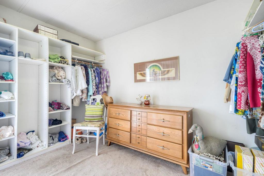 18218 Paradise Mountain Road Valley Center, CA 92082 - Photo 29 of 36 a view of a bedroom with baby toys and lounge chair
