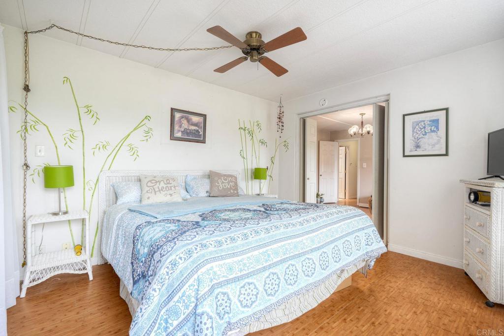 18218 Paradise Mountain Road Valley Center, CA 92082 - Photo 30 of 36 a bedroom with a bed mirror and a window