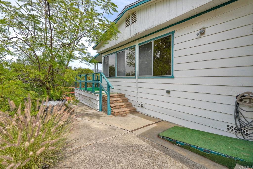 18218 Paradise Mountain Road Valley Center, CA 92082 - Photo 33 of 36 a view of a house with a yard and wooden fence