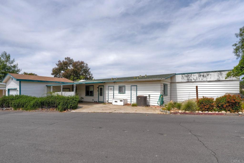 18218 Paradise Mountain Road Valley Center, CA 92082 - Photo 4 of 36 a front view of house with yard and green space