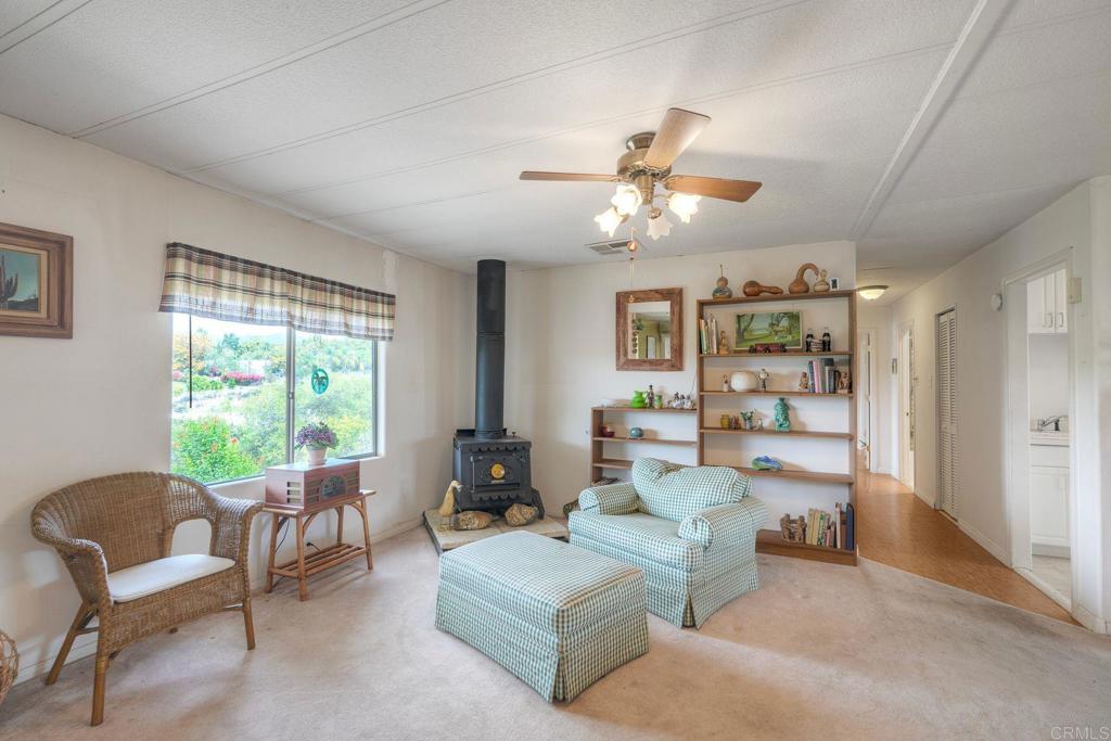 18218 Paradise Mountain Road Valley Center, CA 92082 - Photo 6 of 36 a living room with furniture and a large window