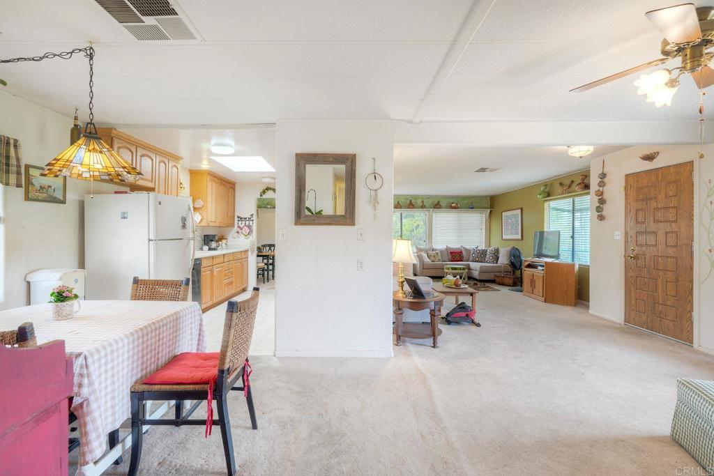 18218 Paradise Mountain Road Valley Center, CA 92082 - Photo 7 of 36 a living room with furniture a table and chairs