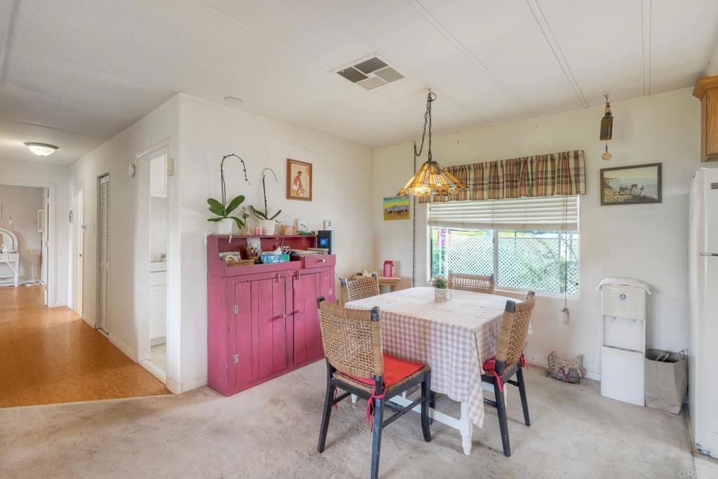 18218 Paradise Mountain Road Valley Center, CA 92082 - Photo 8 of 36 a dining room with furniture window and wooden floor