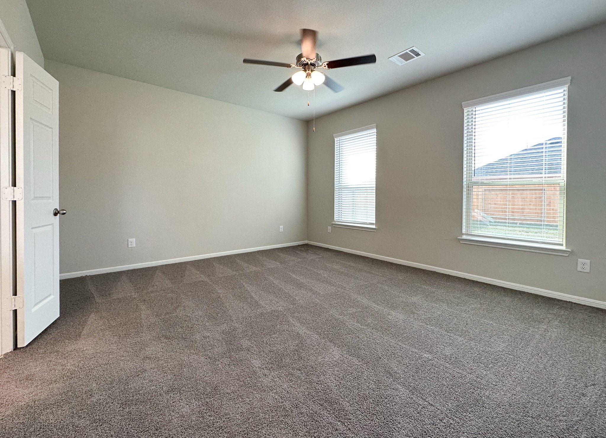 27079 Badger Way Magnolia, TX 77354 - Photo 15 of 40 an empty room with chandelier fan and windows