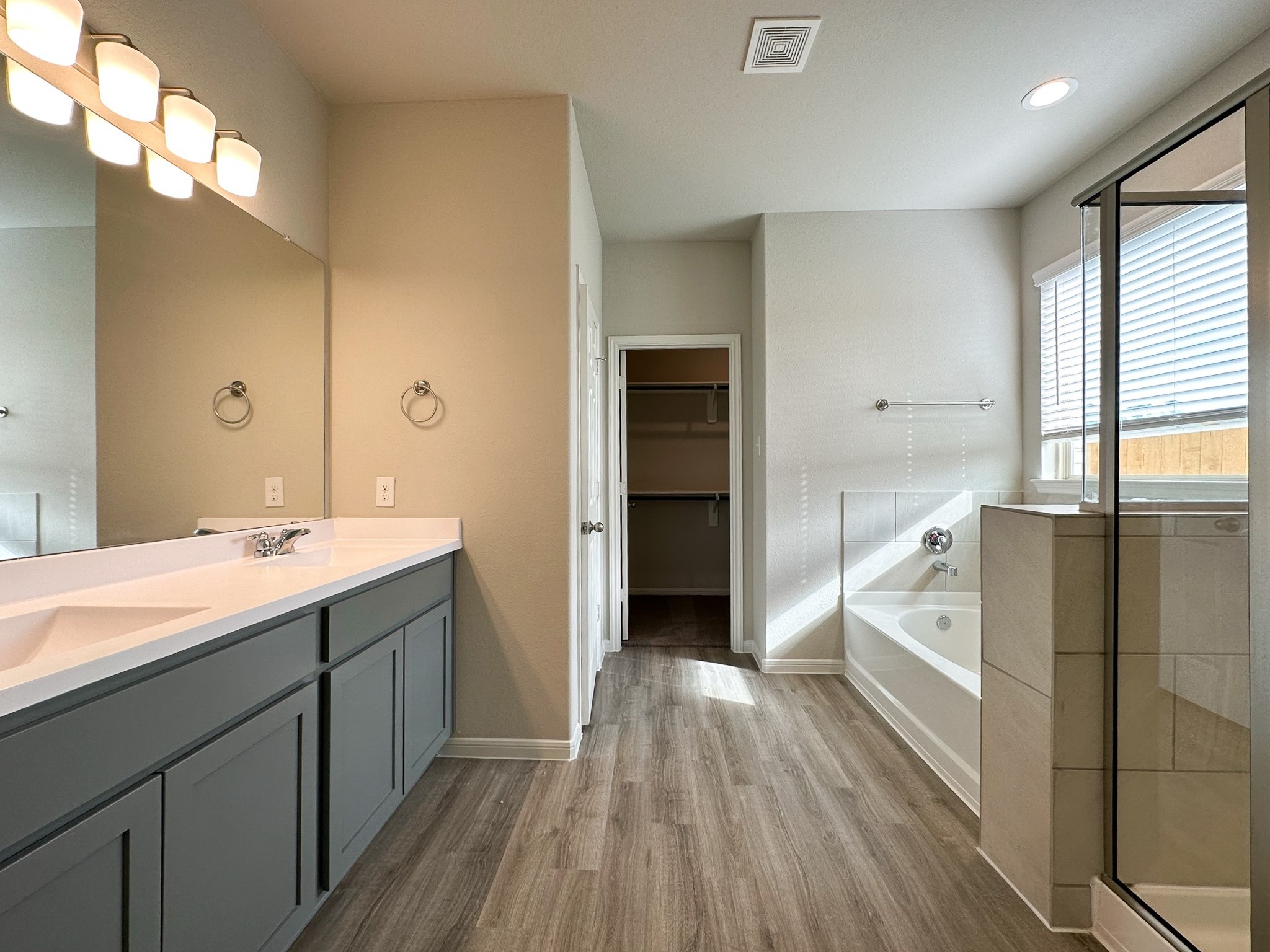 27079 Badger Way Magnolia, TX 77354 - Photo 17 of 40 a spacious bathroom with a double vanity sink and a mirror