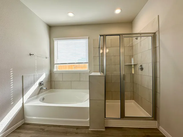 a bathroom with a bathtub and a shower