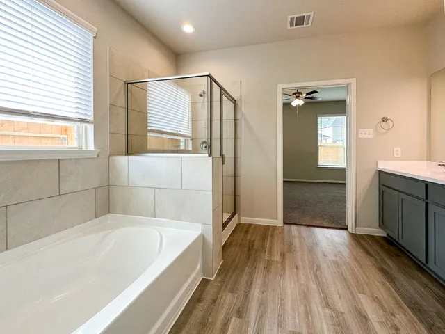 a bathroom with a bathtub and a sink