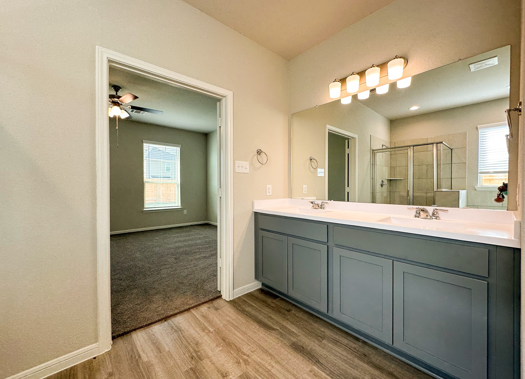 27079 Badger Way Magnolia, TX 77354 - Photo 24 of 40 a spacious bathroom with a double vanity sink and a mirror