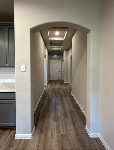 a view of hallway with wooden floor
