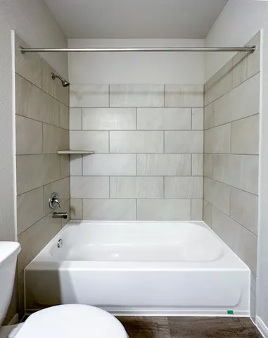 a bathroom with a bathtub and shower