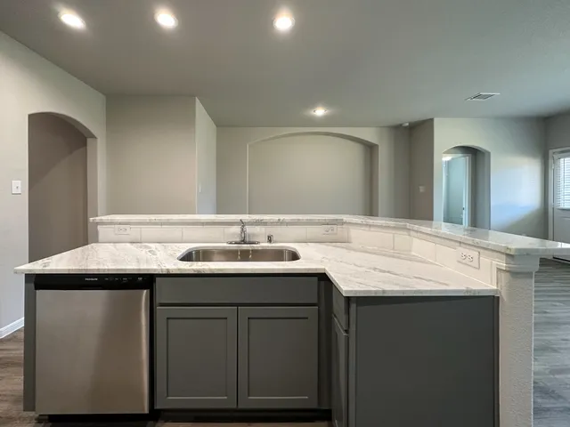 a bathroom with a granite countertop sink a mirror and a vanity