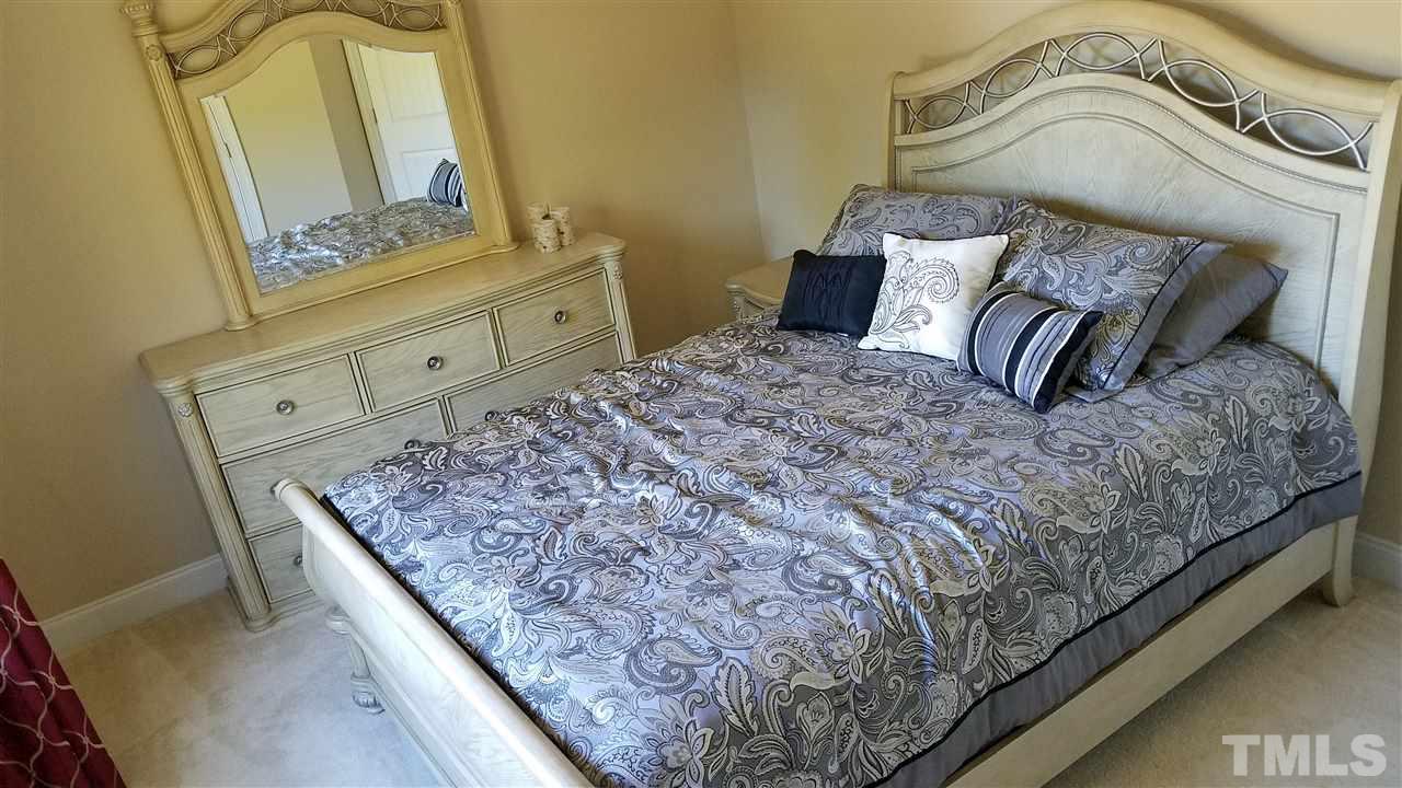 115 Maraketch Court Raleigh, NC 27603 - Photo 19 of 29 Don't be deceived! There is a lot of space in this room! The bed is a queen and the dresser is large!