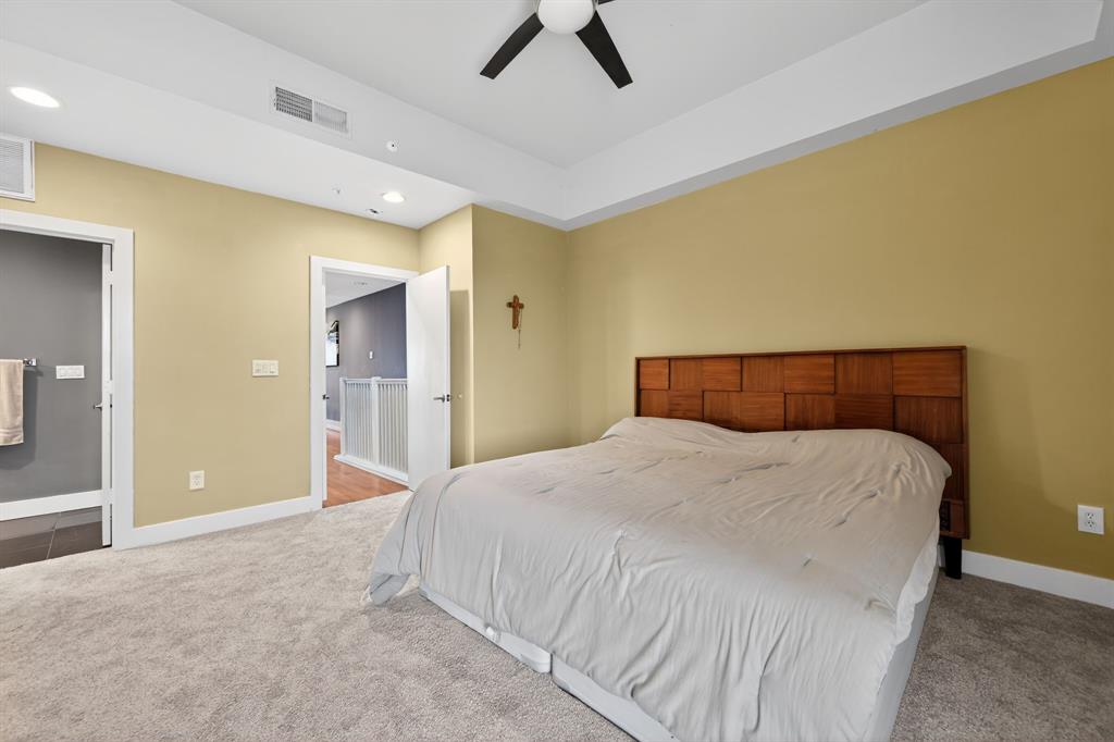 5055 Addison Circle, Unit 713 Addison, TX 75001 - Photo 15 of 40 a bedroom with a bed and a chandelier
