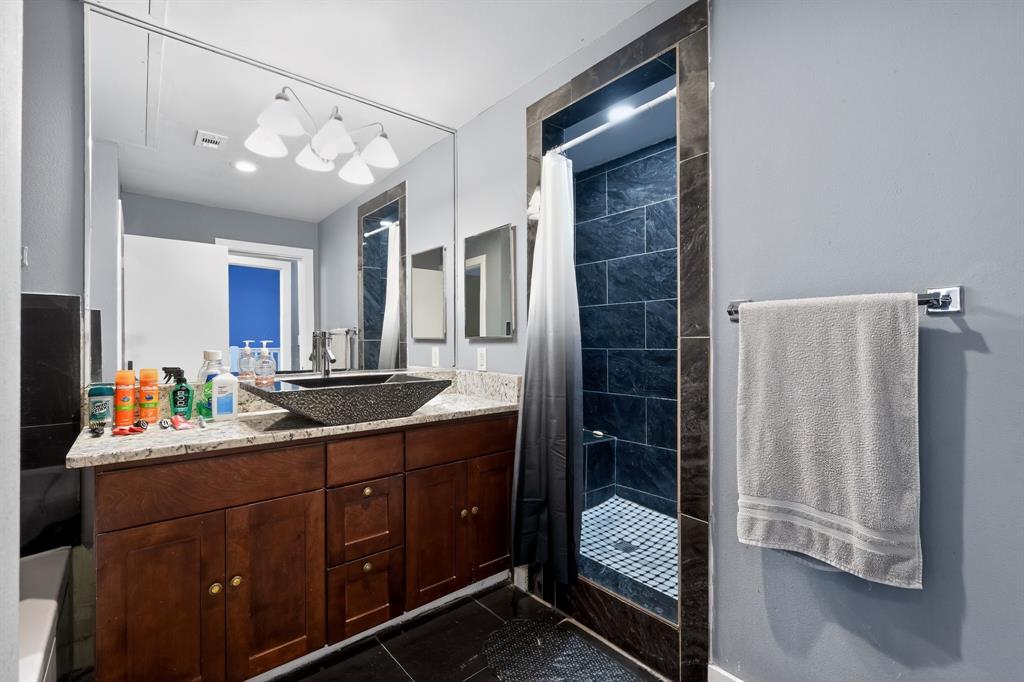 5055 Addison Circle, Unit 713 Addison, TX 75001 - Photo 22 of 40 a bathroom with a sink vanity and a mirror