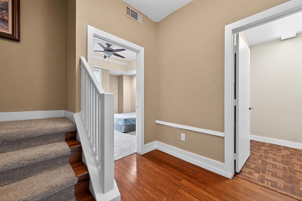 5055 Addison Circle, Unit 713 Addison, TX 75001 - Photo 25 of 40 a view of a hallway with wooden floor and entryway