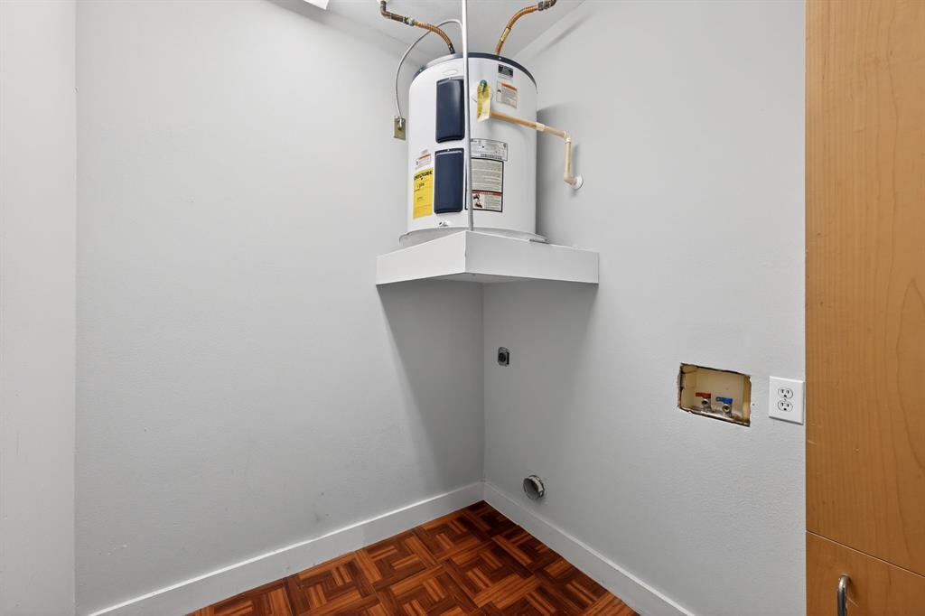 5055 Addison Circle, Unit 713 Addison, TX 75001 - Photo 26 of 40 Dedicated utility space featuring a water heater on a raised platform