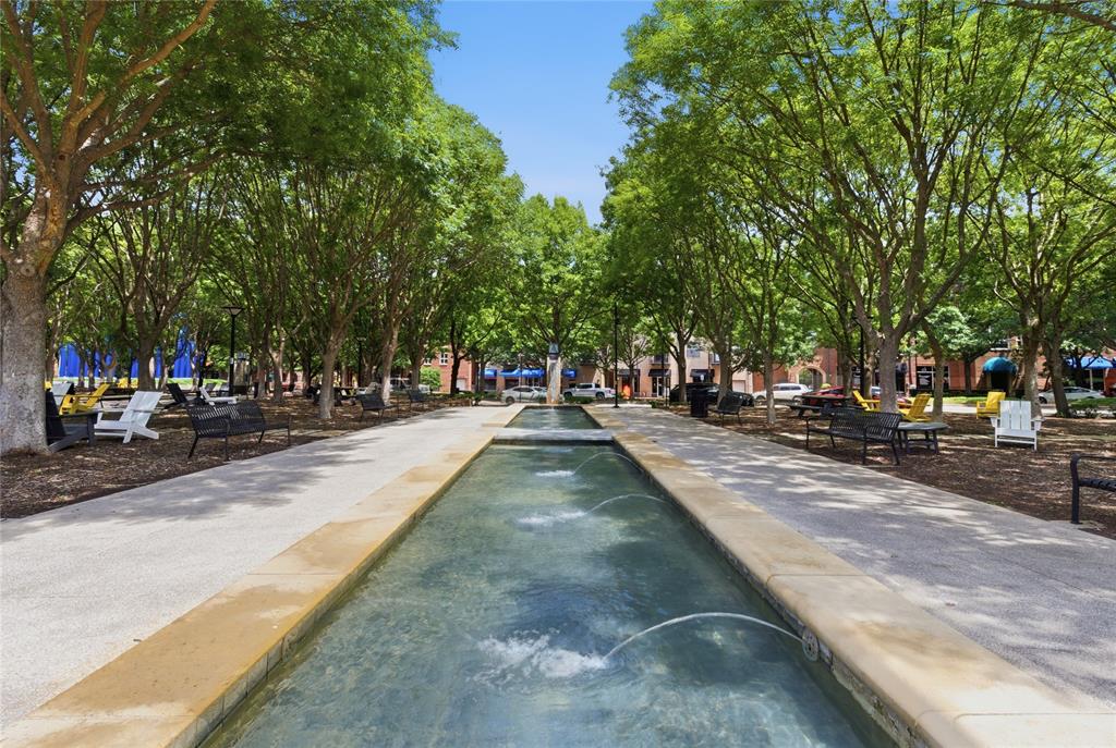 5055 Addison Circle, Unit 713 Addison, TX 75001 - Photo 36 of 40 Central water feature with multiple fountains, flanked by mature trees and paved pathways
