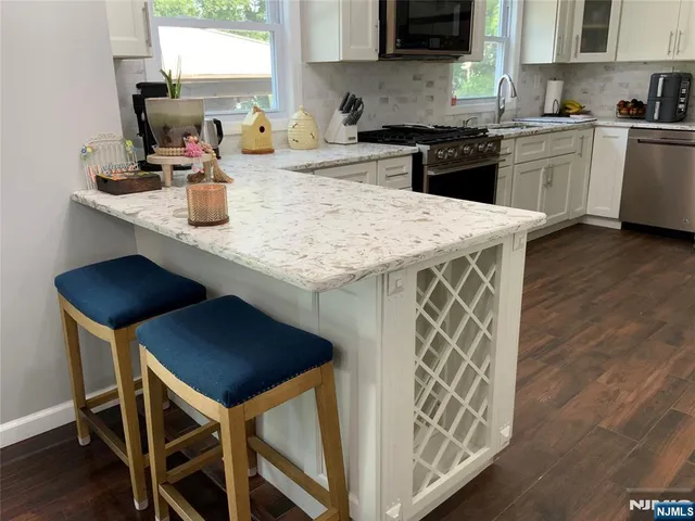 a kitchen with a sink cabinets and wooden floor